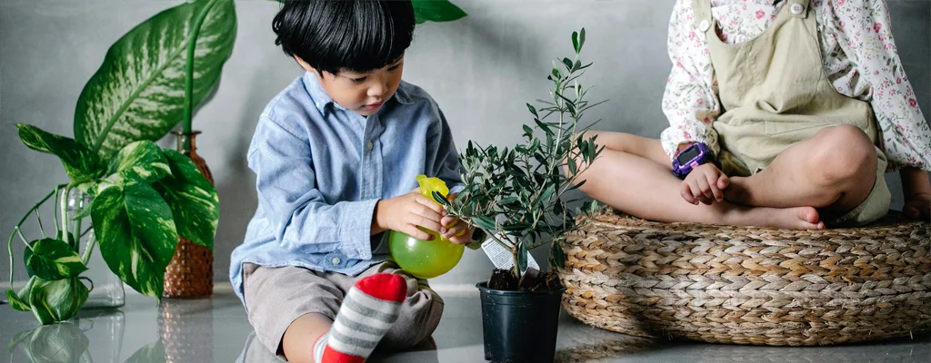child taking care of plant